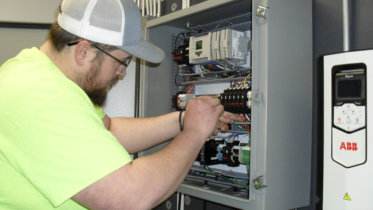 Electrical student working on an electrical panel.