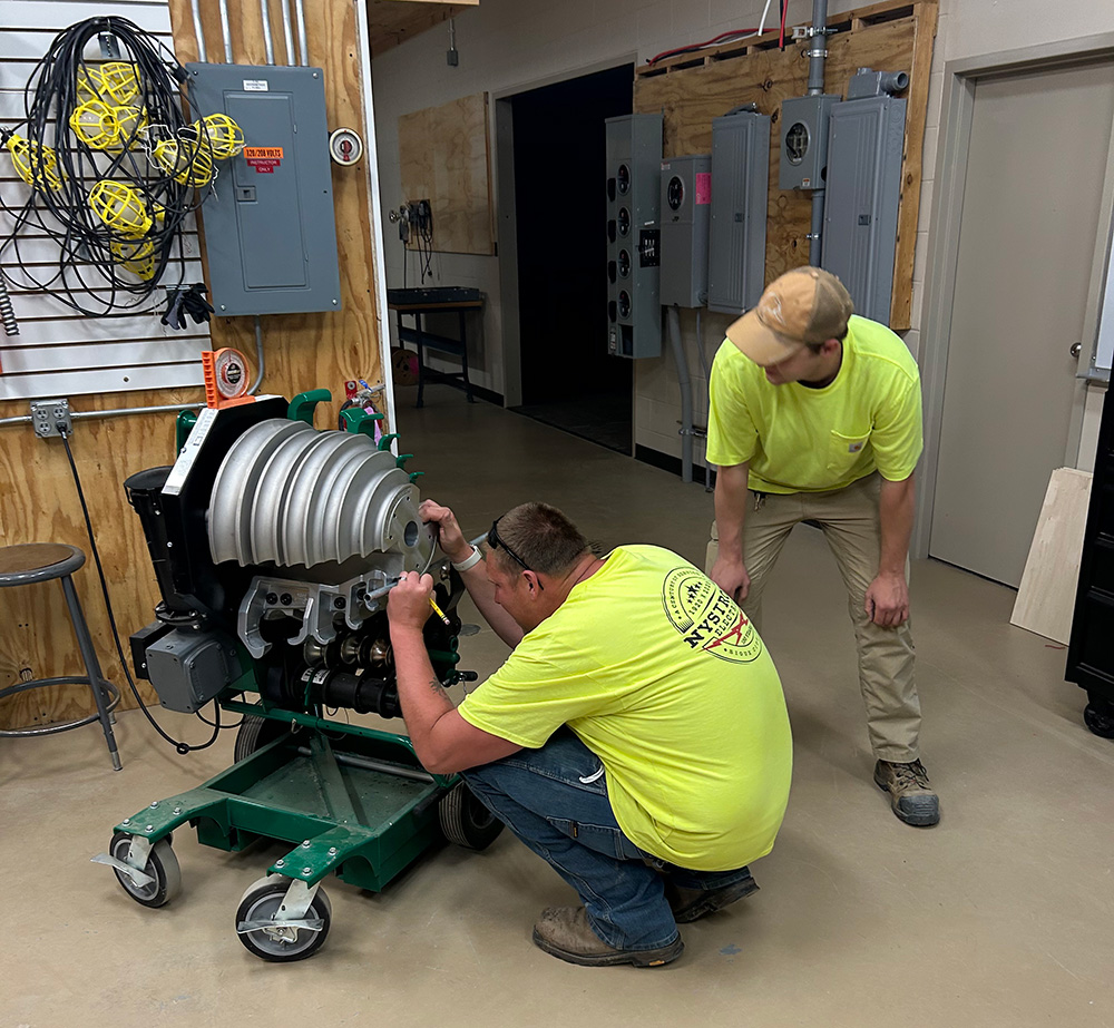 Students working on electrical projects in a classroom.